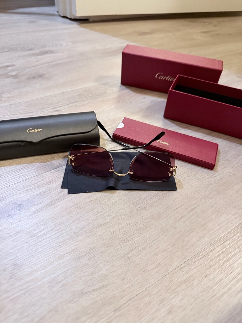 Cartier Women's Rimless Sunglasses with Burgundy Lenses and Gold Accents